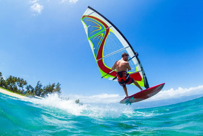 Windsurfing over clear water